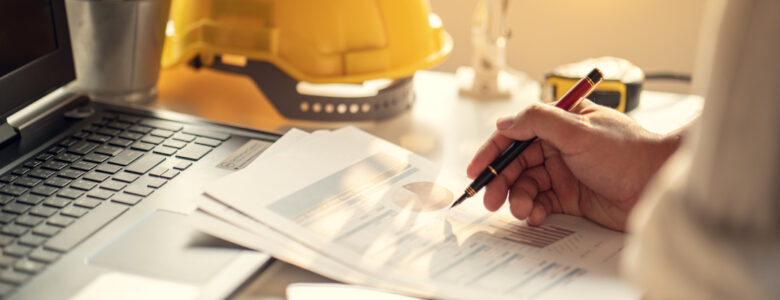 Hand of Business people working document about budget profits and planning of construciton project